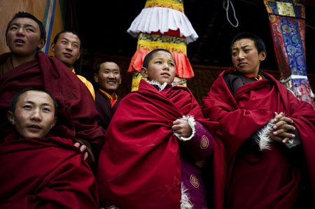 Monks watch the Lamaist devil dance ceremony at Tsurpu Monastery, about 70 kilometers of Lhasa, capital of southwest China's Tibet Autonomous Region, Feb. 23, 2009. 