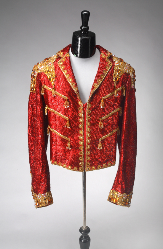 A zip front jacket with wide lapels completely covered in red sequins with gold stripes terminating in gold tassels down front, with matching gold cuffs and epaulets. Created for Jackson in the 1980s. Estimate: $4,000 - $6,000 [China.org.cn/Julien&apos;s Auctions/Shaan Kokin] 