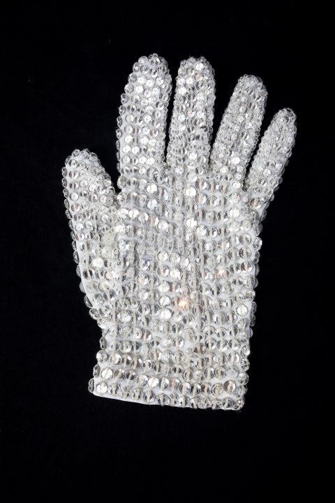 A custom designed white spandex, right hand glove completely covered in clear Swarovski crystal loch rosen crystals. 