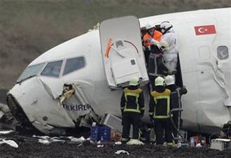 Rescue workers examine the scene of a plane crash near Amsterdam, Netherland, Wednesday Feb.25, 2009.[Frank Augstein/CCTV/AP Photo] 