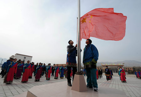 Students salute at the national flag-raising ceremony on the first day of new semester in the School for Nationalities in Tianzhu Tibet Autonomous County, northwest China's Gansu Province, Feb. 25, 2009. Tibetans across China are celebrating the 50th Tibetan New Year after the Democratic Reform with their old traditions. (Xinhua/Han Chuanhao)