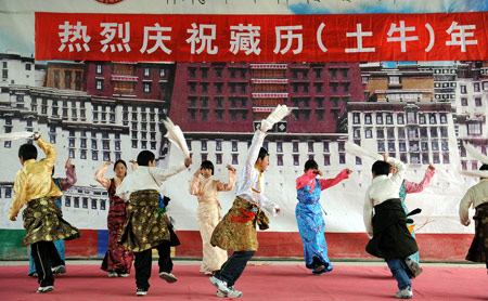 Students of Tibetan ethnic group perform in celebration of the Tibetan New Year at Tibetan School in Jinan, capital of east China's Shandong Province, Feb. 25, 2009. Tibetans across China are celebrating the 50th Tibetan New Year after the Democratic Reform with their old traditions. (Xinhua/Fan Changguo)