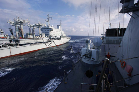 China's destroyer 'Guangzhou' (R) gets supplies from the comprehensive supply vessel 'Nancang', on the South China Sea, south China, Feb. 24, 2009. 