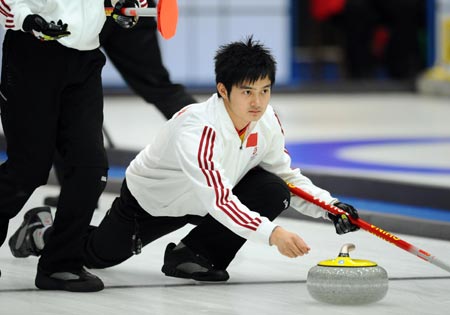 China's Xu Xiaoming acts during the men's curling match against South Korea in the 24th World Winter Universiade at Harbin, capital city of northeast China's Heilongjiang Province, Feb. 26, 2009. China took a bronze medal of the event by beating South Korea 9-5. (Xinhua/Chen Kai)