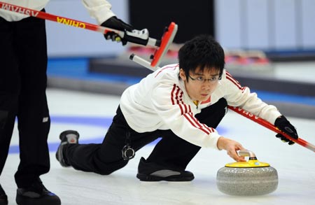 China's Zang Jialiang acts during the men's curling match against South Korea in the 24th World Winter Universiade at Harbin, capital city of northeast China's Heilongjiang Province, Feb. 26, 2009. China took a bronze medal of the event by beating South Korea 9-5. (Xinhua/Chen Kai)