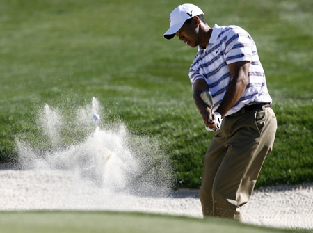 Tiger Woods hits a bunker shot on the 14th hole which went in the hole for a birdie during his second round loss to Tim Clark at the World Golf Championships Accenture Match Play Championship Thursday, Feb. 26, 2009, in Marana, Ariz. Tiger woods playing his first tournament after an eight-month absence, is down three holes to Tim Clark through 13 in the second round of the World Golf Championships Match Play event. (Xinhua/Reuters Photo) 