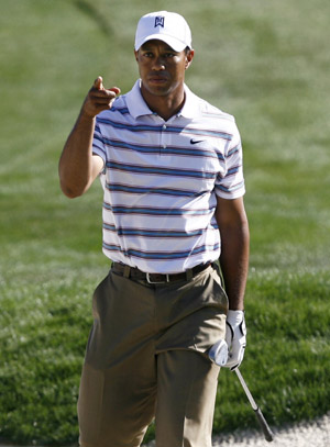 Tiger Woods points after his bunker shot went into the cup on the 14th green during his second round loss to Tim Clark at the World Golf Championships Accenture Match Play Championship Thursday, Feb. 26, 2009, in Marana, Ariz. Clark won 4 and 2. (Xinhua/Reuters Photo) 
