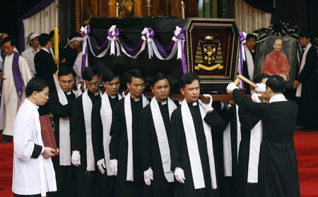 Vietnamese Catholics carry the coffin of the former Hanoi Archbishop, Cardinal Paul Joseph Pham Dinh Tung, during his funeral at the St. Joseph Cathedral in Hanoi February 26, 2009.