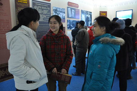 Photo taken on Feb. 26, 2009 shows a college student and her mother talk to Xhinhuanet on their feelings at the 50th Anniversary of Democratic Reforms in Tibet Exhibition, which runs from Feb. 24 to Apr. 10 in the Exhibition Center of the Cultural Palace of Nationalities, Beijing. 