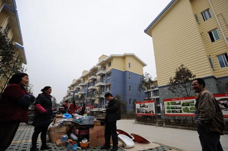 Several villagers sell commodities at Shibei New Village of Xiang'e Township in Dujiangyan City, southwest China's Sichuan Province, Feb. 25, 2009. 