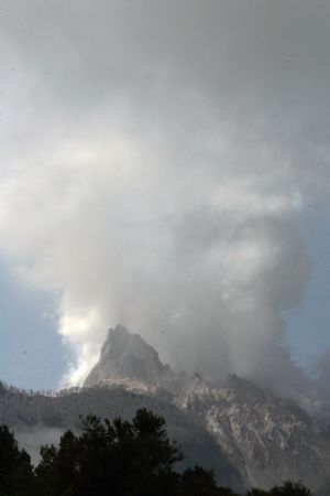 Smoke rises from Chaiten volcano near Chaiten town, located some 1,200 km south of Santiago, Chile, Feb. 26, 2009. The Chaiten volcano, which started erupting on Feb. 19, has buried the neighboring towns under a blanket of ashes.