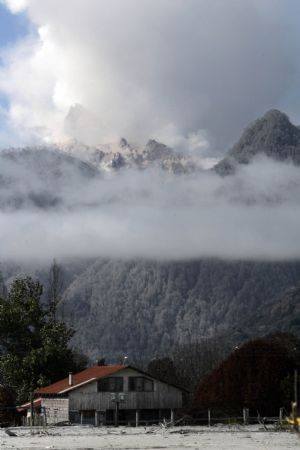 Smoke rises from Chaiten volcano near Chaiten town, located some 1,200 km south of Santiago, Chile, Feb. 26, 2009. The Chaiten volcano, which started erupting on Feb. 19, has buried the neighboring towns under a blanket of ashes.