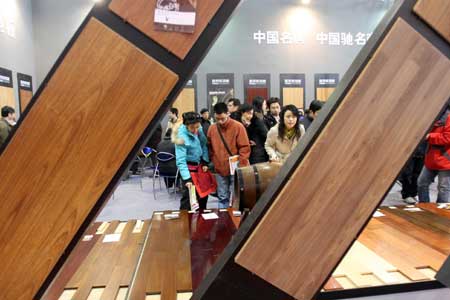 Some Chinese visit pieces of floor plank at a home decoration fair in Beijing, Feb. 28, 2009. 