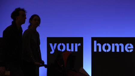 Visitors are silhouetted during the professional day of the 50th Batibouw in Brussels, capital of Belgium, on Feb. 27, 2009. 