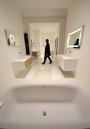 A visitor walks past a sample bathroom during the professional day of the 50th Batibouw in Brussels, capital of Belgium, on Feb. 27, 2009. Batibouw, the exhibition of construction, decoration and innovation with a history of half a century, was opened to public on Saturday.