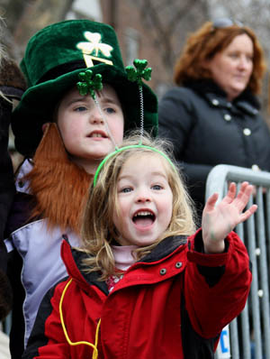 A child waves to the parade in Queens of New York, the United States, on March 1, 2009, prior to the Saint Patrick's Day. Saint Patrick's Day parades are now held throughout not only Ireland but also countries with big emigrant communities like the United States and Britain. The Saint Patrick's Day falls on March 17 annually.