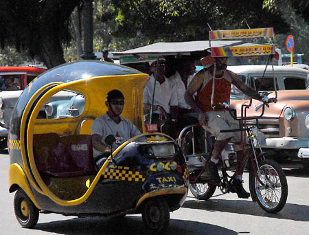 A trike of autobike runs in Havana, Cuba, Feb. 28, 2009. In Havana, weckers, trikes, carriages along with buses and taxis compose the city's main public transportation system. These vehicles witnessed the city's development and change.