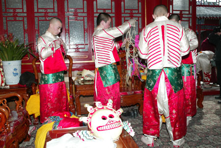 The Buzha, a masked dance used in Tibetan Buddhism to exorcize devils, was performed in Yonghegong Lama Temple on Feb. 24, 2009. Wearing different masks of demons and skulls, the Lamas of the temple danced to the accompaniment of traditional Tibetan instruments and at the end, they threw the model of the devil into fire, symbolizing the deterioration of the devil and pacifying of the world. (By Wu Chuanjing, chinadaily.com.cn)
