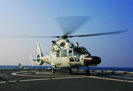 helicopter conducts a takeoff and landing training on China's destroyer 'Guangzhou' in the Indian Ocean on the way to Pakistan March 2, 2009.