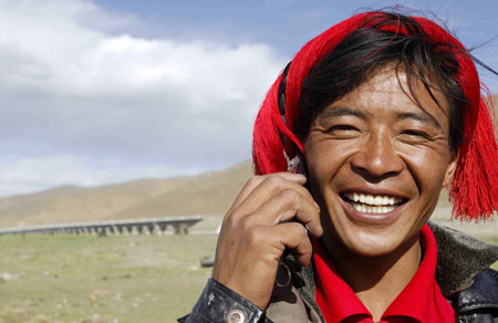 A herdsman of the Tibetan ethnic group talks on the mobile phone in northern Tibet Autonomous Region June 26, 2008.