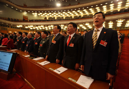 Members of the 11th National Committee of the Chinese People's Political Consultative Conference (CPPCC) sing the national anthem during the opening meeting of the Second Session of the 11th National Committee of the CPPCC at the Great Hall of the People in Beijing, capital of China, March 3, 2009.