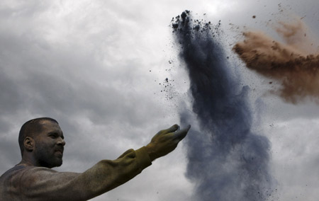 A reveller celebrates Clean Monday by throwing colored flour during a 'flour war', a traditional activity marking the end of the carnival season, in the port town of Galaxidi, some 200km (125 miles) northwest of Athens Mach 2, 2009.