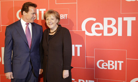 California Governor Arnold Schwarzenegger (L) and German Chancellor Angela Merkel pose for the media during a photo call before the opening ceremony of the CeBIT computer fair in Hanover March 2, 2009. 