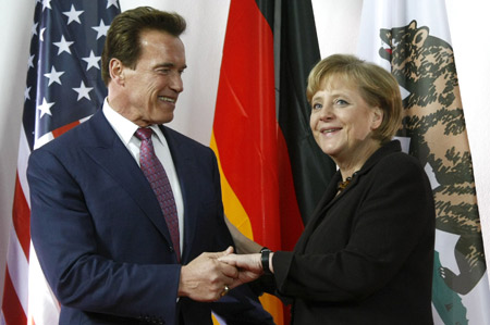 California Governor Arnold Schwarzenegger (L) is welcomed by German Chancellor Angela Merkel upon his arrival before the opening ceremony of the CeBIT computer fair in Hanover March 2, 2009.