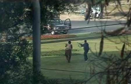 A video grab shows gunmen firing in the direction of a police vehicle in Lahore March 3, 2009. 