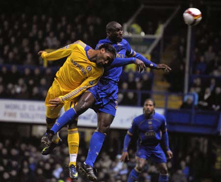 Chelsea's Didier Drogba (L) challenges Portsmouth's Sol Campbell during their English Premier League soccer match at Fratton Park in Portsmouth March 3, 2009.