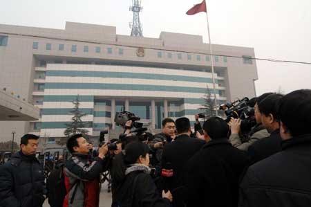 Reporters interview a spokesman of Shijiazhuang Intermediate People's Court after an auction of scandal-hit Sanlu dairy company in Shijiazhuang, capital of north China's Hebei Province, on March 4, 2009. Beijing-based dairy producer Sanyuan won the bid of Sanlu with the price of 616.5 million RMB (about 90 million USD).