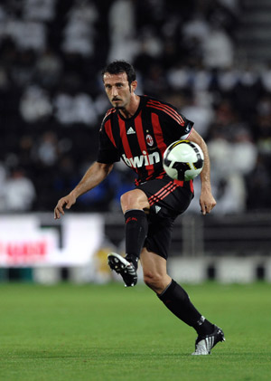 AC Milan's Giuseppe Favalli kicks the ball during the soccer match against Al-Sadd at the Jassim Bin Hamad stadium in Doha, Qatar, March 4, 2009. [Xinhua]