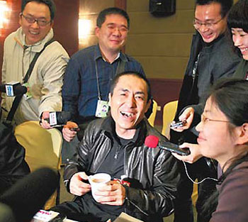 Zhang Yimou is surrounded by mediapersons yesterday on the sidelines of the CPPCC session. [Jiang Dong/China Daily] 