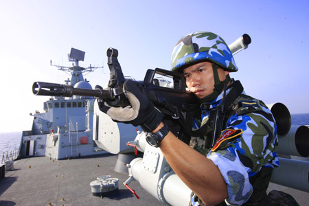 Chinese marine special force corps attend a drill on board of destroyer 'Guangzhou' in the Indian Ocean on the way to Pakistan March 4, 2009. A Chinese naval task force including destroyer 'Guangzhou' and a helicopter will attend the 'Peace-09' exercise in the seas off Pakistan. 