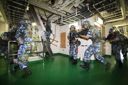 Chinese marine special force corps attend a drill on board of destroyer 'Guangzhou' in the Indian Ocean on the way to Pakistan March 4, 2009. A Chinese naval task force including destroyer 'Guangzhou' and a helicopter will attend the 'Peace-09' exercise in the seas off Pakistan. 