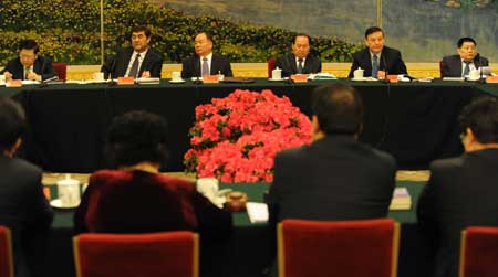 Deputies to the Second Session of the 11th National People's Congress (NPC) from northwest China's Xinjiang Uygur Autonomous Region deliberate the government work report at the Great Hall of the People in Beijing, capital of China, March 6, 2009. (Xinhua/Xu Liang) 