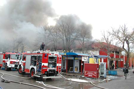 Firefighters try to put out a fire at a market where there are many Chinese shop owners in Sofia, capital of Bulgaria, on March 5, 2009. A fire broke out in a shopping section where there are more than 20 Chinese stalls on early Thursday. The fire is still burning and no casualties were reported so far. (Xinhua/Wang Meng)