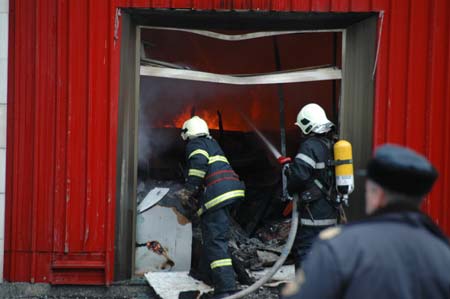 Firefighters try to put out a fire at a market where there are many Chinese shop owners in Sofia, capital of Bulgaria, on March 5, 2009. A fire broke out in a shopping section where there are more than 20 Chinese stalls on early Thursday. The fire is still burning and no casualties were reported so far. (Xinhua/Wang Meng)
