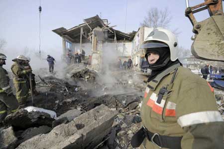 Rescuers look through debris in Russia's troubled North Caucasus region of Ingushetia after an explosion, March 5, 2009. A suspected gas explosion devastated a residential building killing six people and injuring seven, Russian media reported. 