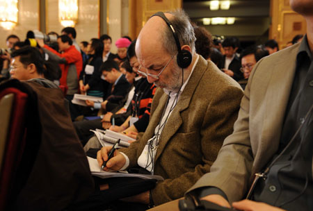 A foreign journalist works during a press conference on dealing with the global financial crisis and maintaining steady and relatively rapid economic growth held by the Second Session of the 11th National People's Congress (NPC) at the Great Hall of the People in Beijing, capital of China, March 6, 2009. 