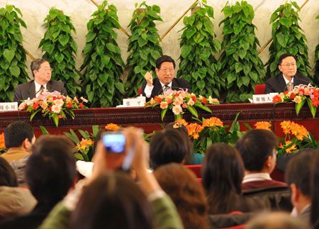 Zhang Ping (C), minister in charge of the National Development and Reform Commission of China, Chinese Finance Minister Xie Xuren (R) and Zhou Xiaochuan (L), governor of the People's Bank of China, attend a press conference on dealing with the global financial crisis and maintaining steady and relatively rapid economic growth held by the Second Session of the 11th National People's Congress (NPC) at the Great Hall of the People in Beijing, capital of China, March 6, 2009. 