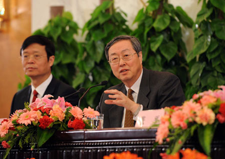 Zhou Xiaochuan (R), governor of the People's Bank of China, answers a question during a press conference on dealing with the global financial crisis and maintaining steady and relatively rapid economic growth held by the Second Session of the 11th National People's Congress (NPC) at the Great Hall of the People in Beijing, capital of China, March 6, 2009.