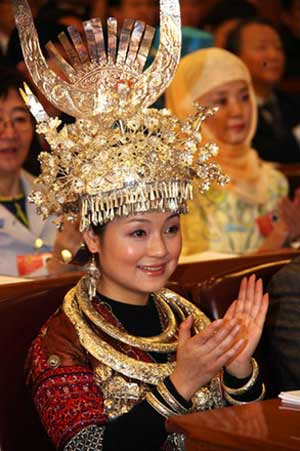 A deputy of Miao minority group from southwest China's Guizhou province claps during the opening ceremony of the Second Session of the 11th National People's Congress (NPC) in Beijing, March 5, 2009. 