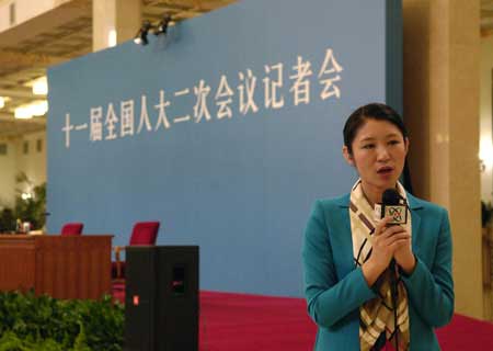 A journalist works prior to Chinese Foreign Minister Yang Jiechi's meeting with the press held by the Second Session of the 11th National People's Congress (NPC) at the Great Hall of the People in Beijing, March 7, 2009.