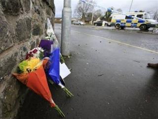 Flowers are laid near the entrance to the Massereene army base in County Antrim. [Peter Muhly/CCTV/AFP] 