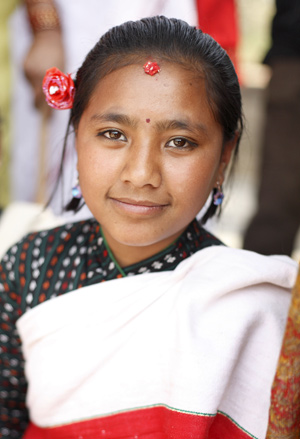 A Nepali girl in traditional dress takes part in a celebration to mark the International Women's Day in Nepal's capital Kathmandu on March 8, 2009. The main theme of the International Women's Day for Nepal this year is 'Voice of All Nepalis: Drafting Women-friendly Constitution.' 