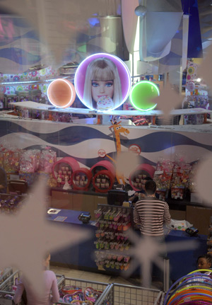 Customers pick up Barbie dolls in the ToysRus at Times Square in New York, the United States, March 7, 2009. Barbie celebrates her 50th birthday on March 9, 2009. (Xinhua/Gu Xinrong)
