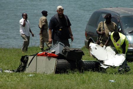 A rescuer puts down wreckage of a crashed cargo plane at Entebbe, 40km south of Kampala, on March 9, 2009. An Illyushin 76 cargo aircraft crashed in Lake Victoria, about 10 km south of Uganda's Entebbe international airport. 11 people aboard were feared dead in the Monday morning tragedy. Salvage efforts are underway. (Xinhua/Ronald Ssekandi)