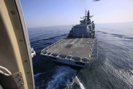 A Chinese navy military helicopter is ready to land on a British warship during the AMAN 09 military exercises at the Arabia Sea off the southern Pakistani port of Karachi, on Mar. 9, 2009. Warships from participating countries Monday began their second phase of the two-week-long AMAN 09 military exercises at the Arabia Sea off the southern Pakistani port of Karachi. (Xinhua/Zha Chunming)