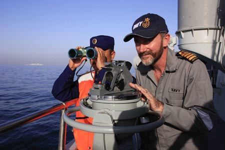 An Australian navy observer (R) watches the AMAN 09 military exercises on China's navy ' Guangzhou' destroyer at the Arabia Sea off the southern Pakistani port of Karachi, on Mar. 9, 2009. Warships from participating countries Monday began their second phase of the two-week-long AMAN 09 military exercises at the Arabia Sea off the southern Pakistani port of Karachi. 